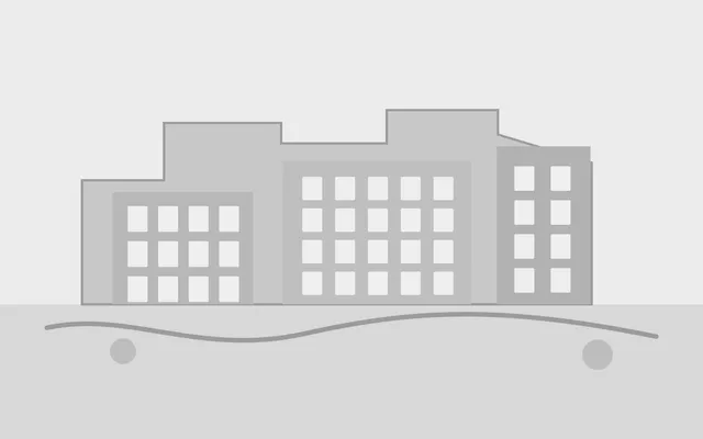 Simple grey architectural massing model with minimal facade detail